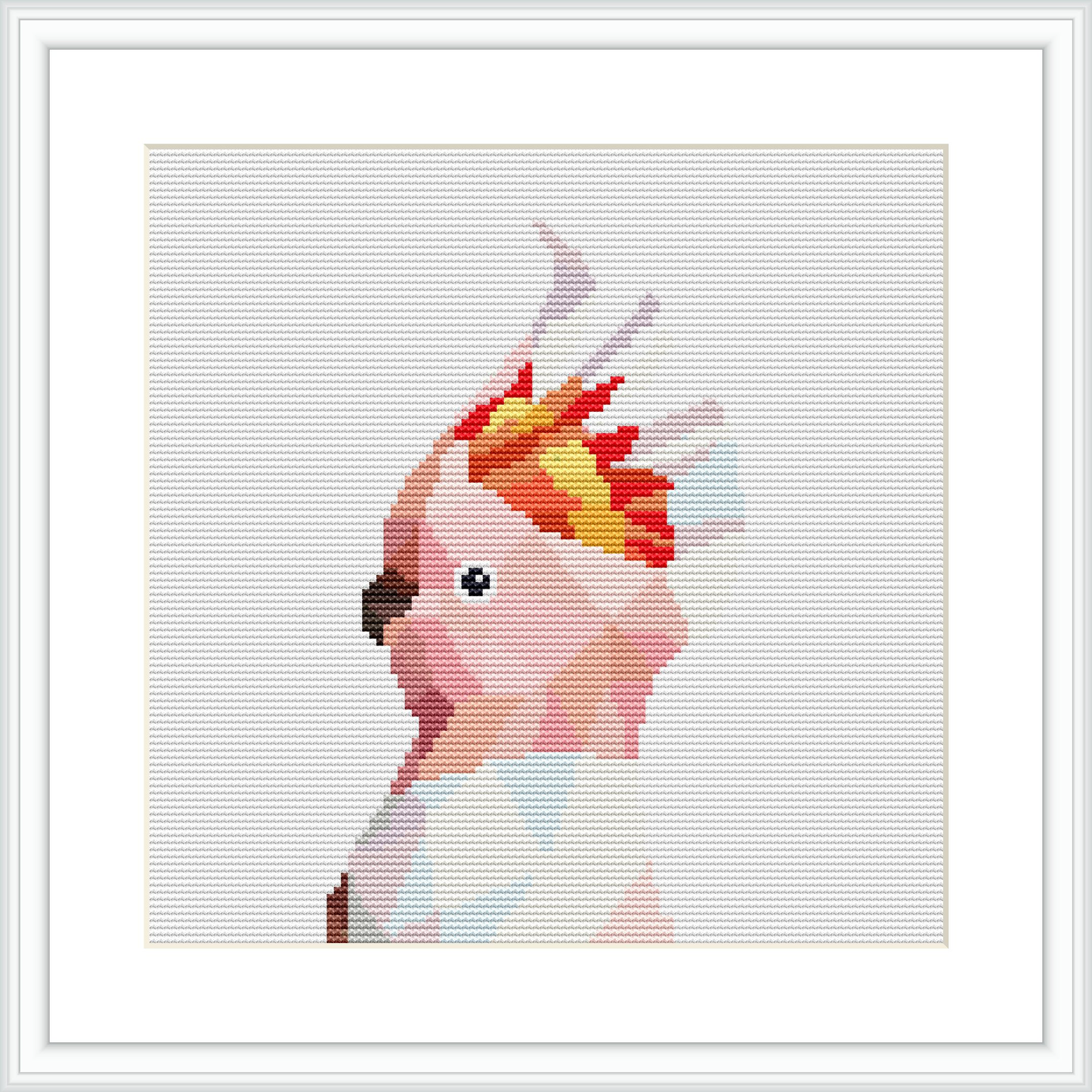 The image features a framed cross stitch design of a pink cockatoo with a vibrant crest, centered on a white background within a square frame.