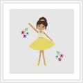 The image features a cross stitch pattern of a ballerina in a yellow dress, with her arms raised gracefully. She is wearing brown ballet shoes and has her hair up in a bun. There are colorful flowers to her right and left on a white background. The overall scene is framed with a simple white border.