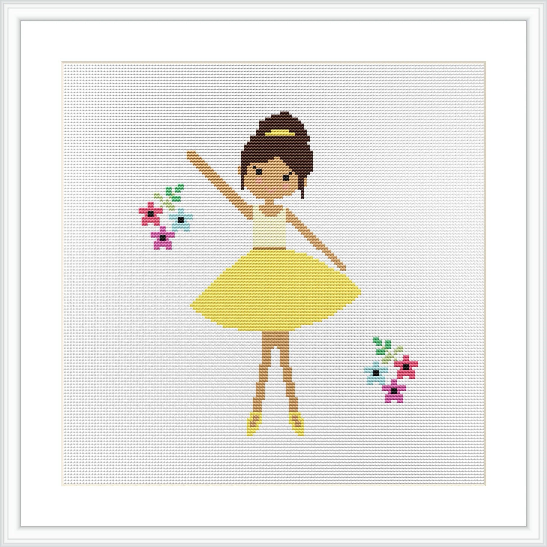 The image features a cross stitch pattern of a ballerina in a yellow dress, with her arms raised gracefully. She is wearing brown ballet shoes and has her hair up in a bun. There are colorful flowers to her right and left on a white background. The overall scene is framed with a simple white border.