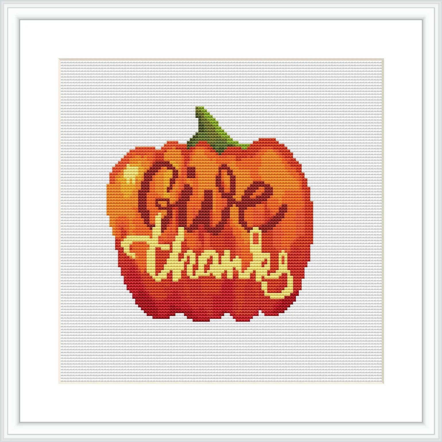 The image depicts a cross stitch pattern of an orange pumpkin with a green stem at the top. Overlaid on the pumpkin is cursive script that reads 'Give Thanks'. The pattern is displayed on a white background, resembling an aida cloth.