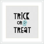 The image presents a framed cross stitch pattern featuring the words 'TRICK OR TREAT' in bold, black letters, above a cute aqua-colored ghost. The background is white and the design is centered within the frame.