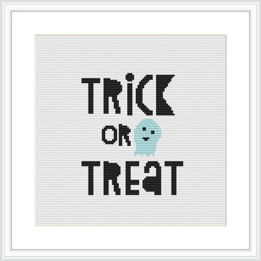 The image presents a framed cross stitch pattern featuring the words 'TRICK OR TREAT' in bold, black letters, above a cute aqua-colored ghost. The background is white and the design is centered within the frame.