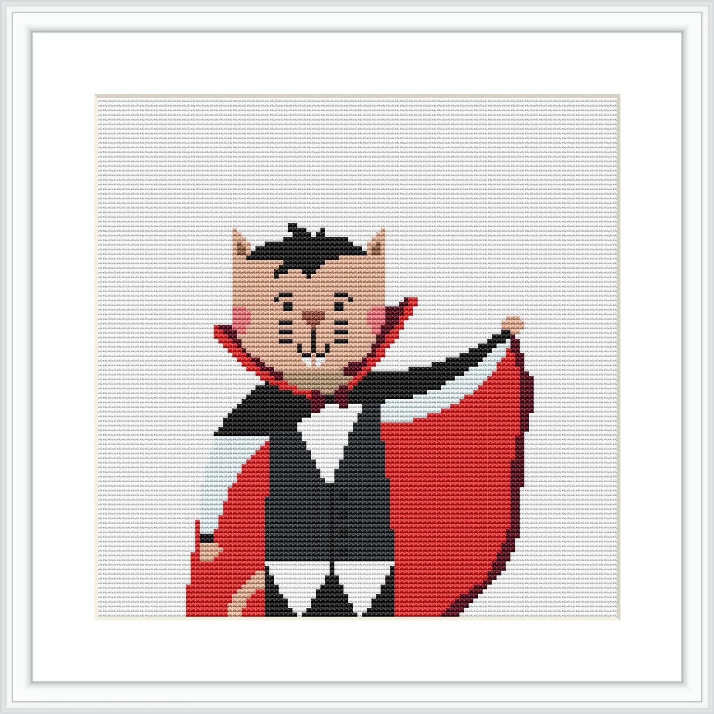 The image features a cross-stitch pattern of a black and gray cat wearing a vampire costume with a red cape and a white collar against a white background. The cat has a playful expression with fangs showing.