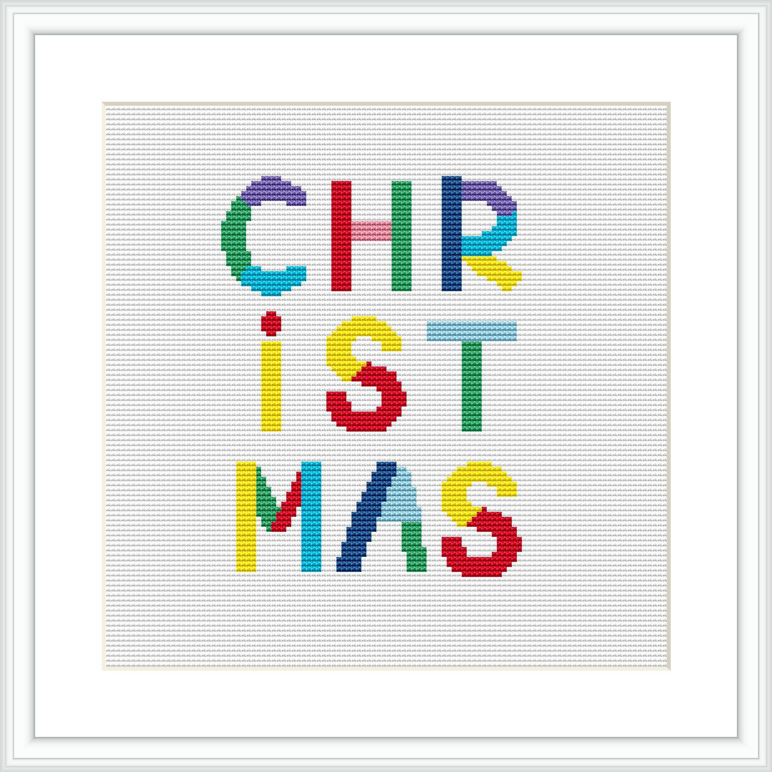 The image depicts a cross stitch design featuring the word 'CHRISTMAS' spelled out in block letters, each letter a different vibrant color, on a white cloth displayed within a square frame.