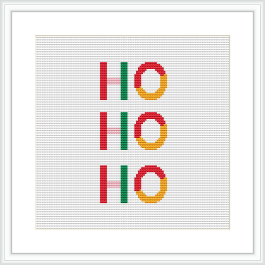 The image shows a cross stitch design with the text 'Ho Ho Ho', where each 'Ho' is arranged vertically and adorned with a circular pattern resembling Christmas wreaths, all stitched onto a white canvas framed in a simple white square frame.