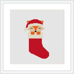 The image depicts a cross-stitch pattern featuring a red Christmas stocking with a fox wearing a Santa hat poking out the top. The fox is illustrated in a stylized, minimalist manner with a white and golden face, and the stocking has a rich red color with a white cuff and toe.