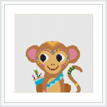 The image depicts a cross stitch pattern of a cartoonish monkey with tribal patterns, situated centrally against a white background, framed in what appears to be a wall mounted picture frame.