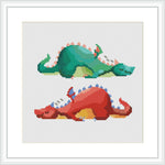 The image features two stylized dragons, one green and one red, each curled up and appearing to be asleep, set against a white background with a border that resembles a picture frame.