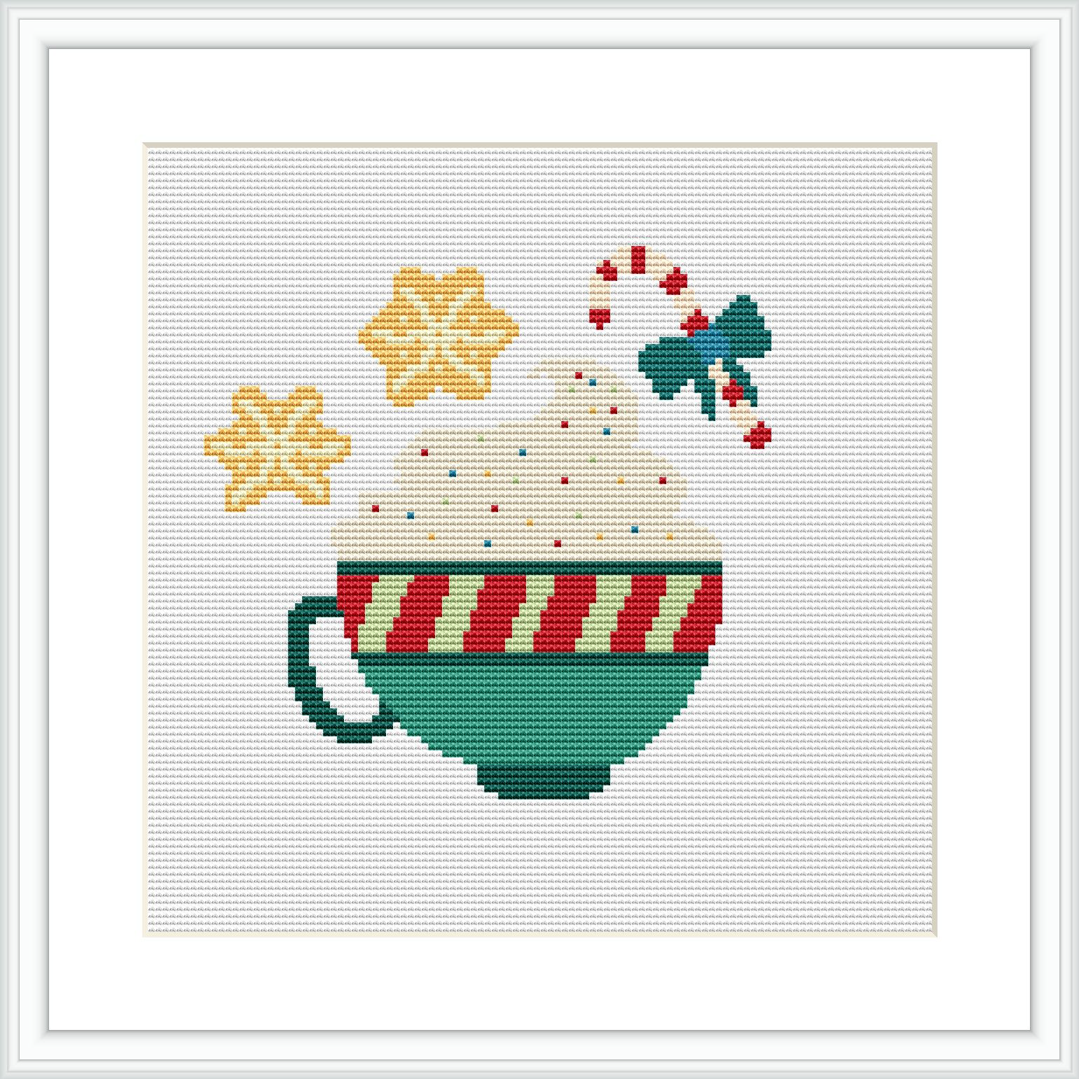 The image displays a cross-stitch pattern of a green and red striped coffee cup with a hot beverage. Above the cup, there are steam swirls, two golden stars, and holly leaves with red berries. The background is plain white, and the pattern is framed within a simple border.