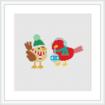 The image features two stylized birds with Christmas-themed attire—a scarf, hat, and holding an ornament—positioned side by side against a plain white background within a grid layout for cross stitching.