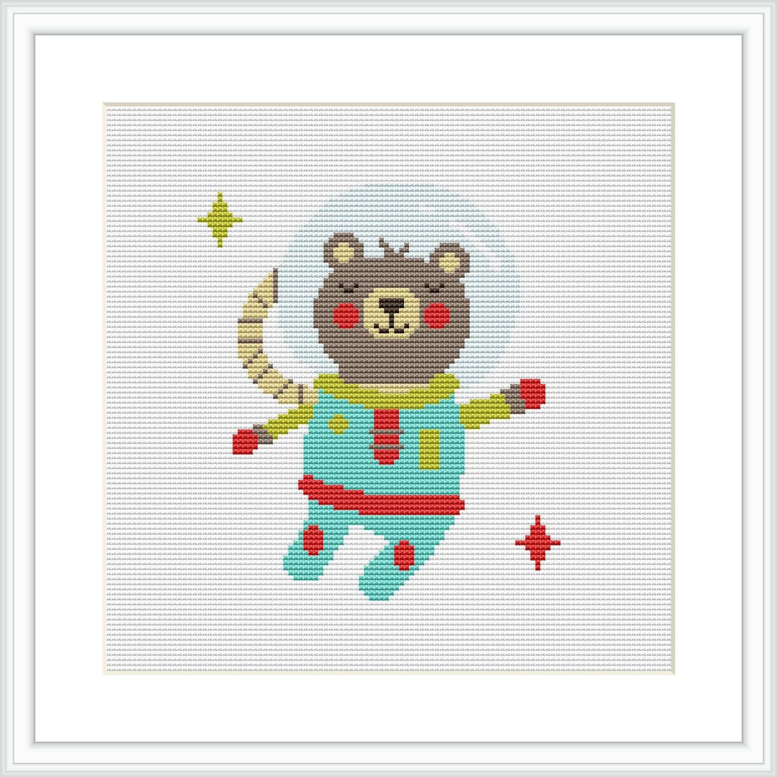 The image displays a cross stitch pattern of a cartoony bear dressed as an astronaut surrounded by stars. The bear is in space, with a half-moon and two individual stars placed near it. The background is plain white.