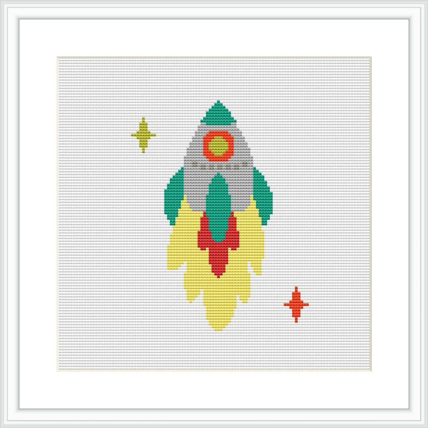 The image showcases a cross stitch pattern of a stylized space rocket with flames at the bottom, accompanied by two stars, one larger on the left and a smaller one on the right.