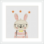 The image displays a cross stitch pattern of a cute rabbit with glasses, wearing a striped garment. The rabbit is centrally placed against a white background with a few orange stars above its head.