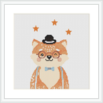 The image presents a framed cross stitch pattern of a stylized fox character. The fox is wearing a black top hat and a blue bow tie, with elegant stripes decorating its fur. Around it, there are five golden stars sprinkled against a white background.