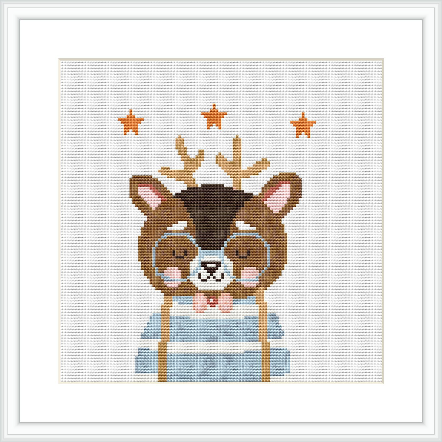 The image displays a framed cross stitch pattern of a cute animal with antlers, dressed in a blue garment, surrounded by small orange stars.