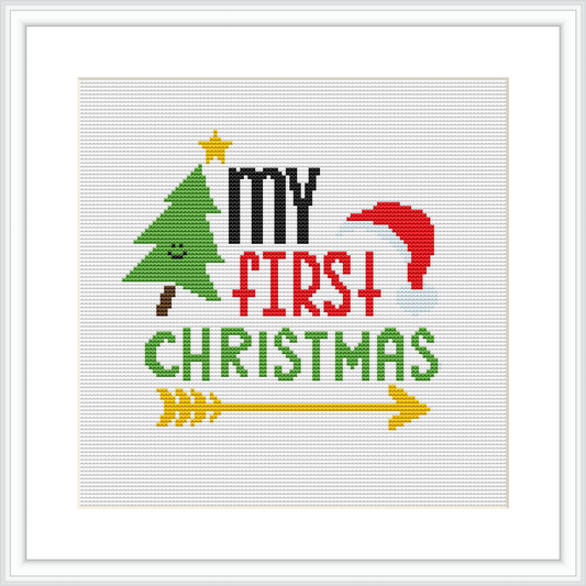 The image showcases a cross stitch pattern featuring the phrase 'My First Christmas' with festive symbols such as a Christmas tree, a Santa hat, and decorative elements like a star and a scroll against a white background.