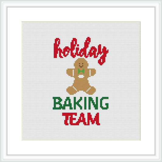 The image depicts a framed cross stitch pattern featuring the words 'Holiday BAKING TEAM' in capitalized letters, with 'Holiday' on top in red, 'BAKING' at the bottom in green, and 'TEAM' in red beneath. A brown gingerbread character is centered between the text, on a white background, surrounded by a festive color palette.