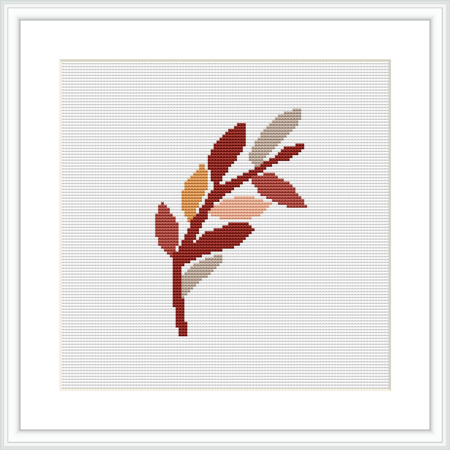 A framed cross stitch pattern showcasing an abstract design of autumn leaves with varying colors on a white background.