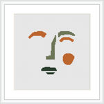 The image displays a framed cross stitch pattern on a white background, featuring abstract shapes reminiscent of the human face, arranged in a sporadic yet balanced manner.