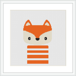 The image features a simplistic cross stitch pattern of a fox's face and upper body, with orange and white colors and black detailing. The fox has a playful expression and is framed by a simple white border inside a square frame.