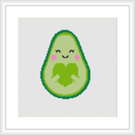 The image depicts a cross stitch pattern of a cute, smiling avocado with rosy cheeks and closed eyes. It's giving itself a hug with a simple green border outline.