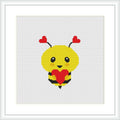 The image shows a yellow bee with red hearts for wings and antennas, holding a larger red heart, centered on a white canvas framed in a square format within a simple black frame.