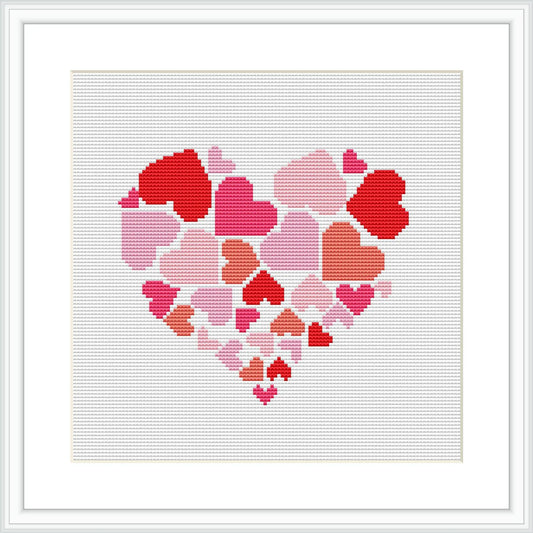 The image showcases a cross stitch pattern represented by a heart shape composed of smaller, pixelated heart motifs in various shades of red and pink, framed with a simple white border on a grid background.