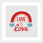 The image shows a framed cross stitch design with a rainbow arcing over the phrase 'LOVE IS LOVE', flanked by two teal hearts, against a white fabric background.