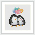 The image depicts two penguins standing side by side with their bodies touching, facing forward. Above them are three stylized hearts in a gradient of colors, ranging from teal at the top through purple and pink. The background is plain white.