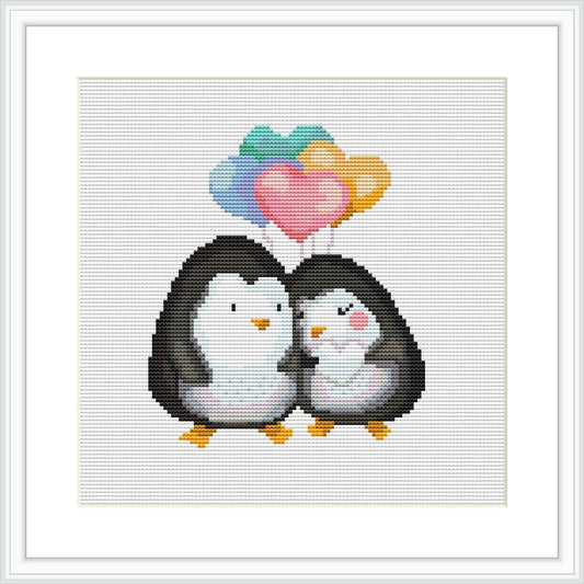 The image depicts two penguins standing side by side with their bodies touching, facing forward. Above them are three stylized hearts in a gradient of colors, ranging from teal at the top through purple and pink. The background is plain white.