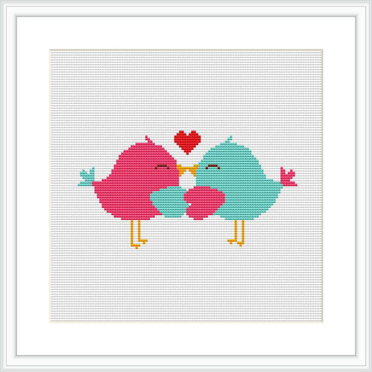 The image depicts two stylized birds facing each other with a heart floating above them. They are positioned centrally on a grid-based canvas which measures 8x8 inches.