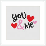 The image displays a cross stitch pattern featuring the phrase 'you & me' in stylized typography with two red and one pink heart shaped figures. The background is white, and the phrase consists of black, red, pink, and gray colors. The design is framed within a simple square frame, suggesting a modern and clean aesthetic.