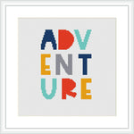 The image features a cross stitch pattern with the word 'ADVENTURE' in block letters, each letter in a unique, bold color. The letters are centered on a white canvas, within a square frame.