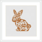 The image displays a cross stitch pattern featuring a bunny silhouette with the words 'HAPPY Easter DAY' inside it. The pattern uses shades of brown and is framed on a white canvas within a square frame.