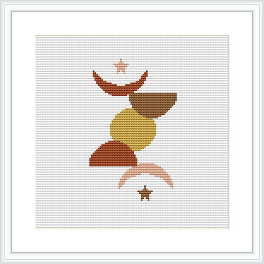 The image shows a framed cross stitch pattern design. It features abstract geometric shapes stacked centrally in a balanced composition. The shapes are filled with flat color blocks in a neutral and earthy palette.