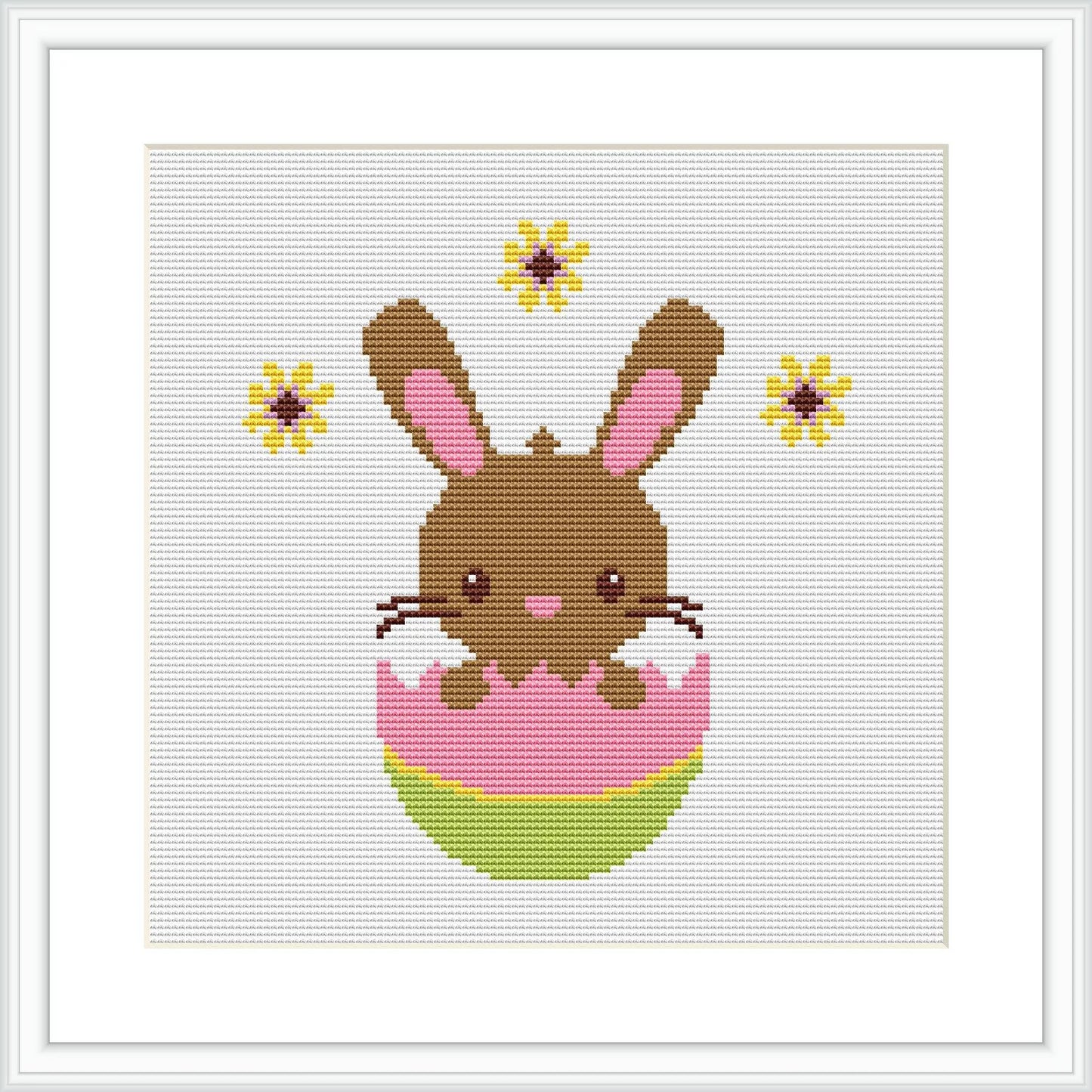 The image shows a pixel art-style cross stitch pattern of a brown Easter bunny with pink inner ears and cheeks, popping out of a decorated pink and green egg. The bunny is centered on a white canvas, with yellow and brown flowers dotted around it.