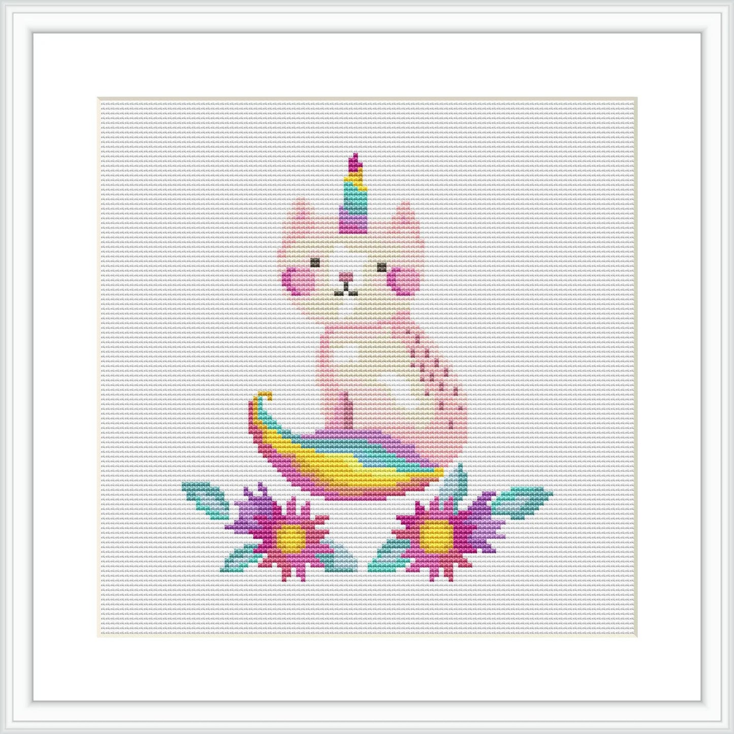 The image showcases a cross stitch pattern of a pink caticorn with a multicolored tail and horn, seated in the center. It is surrounded by flowers with purple petals and yellow centers, set against a plain white background.