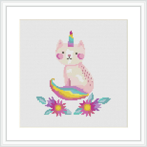 The image showcases a cross stitch pattern of a pink caticorn with a multicolored tail and horn, seated in the center. It is surrounded by flowers with purple petals and yellow centers, set against a plain white background.