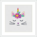 This is a cross stitch pattern design featuring a stylized image of a cat with a unicorn horn, the pattern is predominantly pastel colors with a rainbow gradient on the horn.