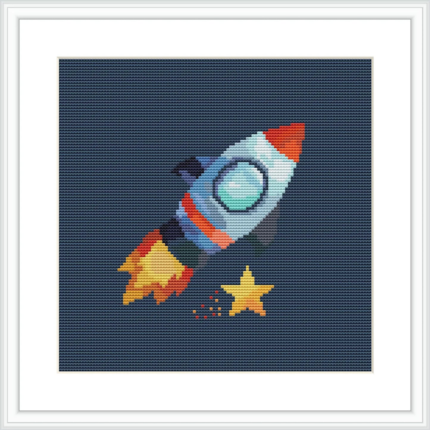 The image depicts a pixelated cross-stitch pattern of a rocket represented in vibrant colors with a dinosaur inside it. The background is a dark navy, simulating space, and there are small stars and a larger star near the rocket.