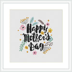 This cross stitch pattern displays the phrase 'Happy Mother's Day' in stylized, cursive typography at the center. Surrounding the text is an assortment of flowers and leaves, creating a wreath-like appearance. It is framed within a simple square border, showcasing the design on an ivory white background.