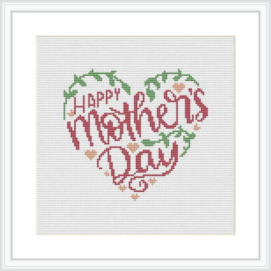 The image features a cross stitch pattern of a heart-shaped wreath composed of flowers and leaves, with the phrase 'Happy Mother's Day' in the center. The pattern is framed within a white square border and appears on a white background.