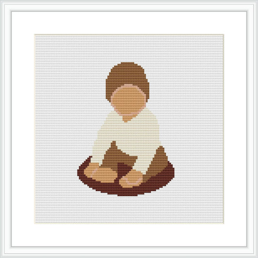 The image depicts a cross stitch pattern of a baby boy seated on the ground. He is wearing a white top and brown pants, immersed in play with an unidentifiable object.