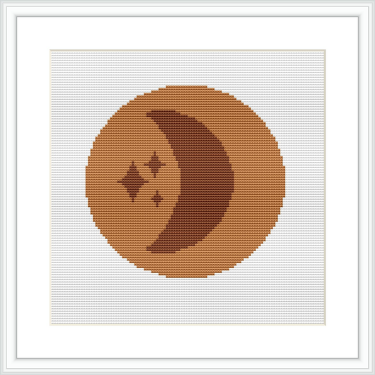 The image features a framed cross stitch pattern with a stylized depiction of a crescent moon and three small stars, centered within a geometric brown circle on an off-white canvas.