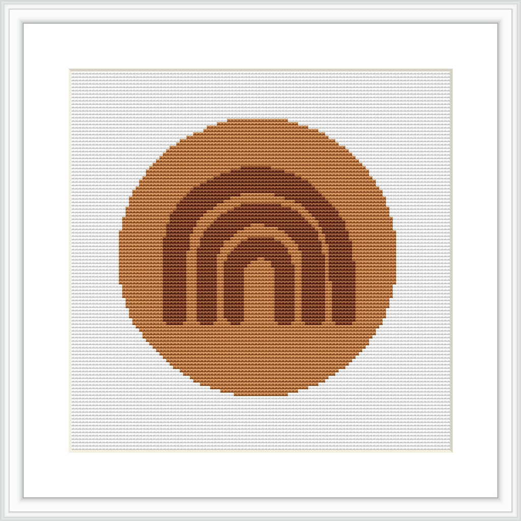 The image depicts a square cross stitch pattern featuring a monochromatic circular arc motif centered within a square frame. The design is composed of earthy brown shades against a white background.