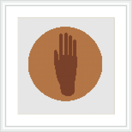 A cross stitch design featuring a singular human hand centered within a round, brown-toned background, all framed by a simple, elegant white border.