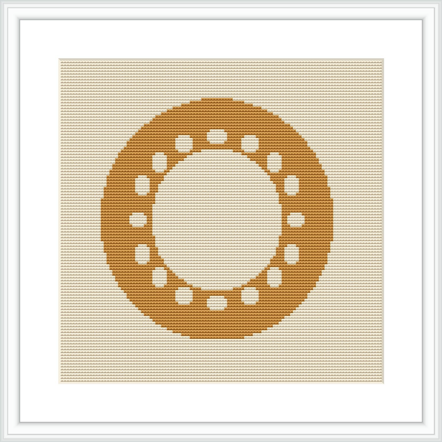 The image displays a framed cross stitch pattern hanging on a wall. The design depicts a centered circular motif made up of small geometric shapes, predominantly in shades of yellow, on an ecru or light beige aida cloth.