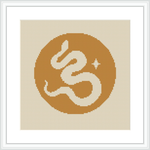 The image showcases a framed cross stitch pattern featuring a stylized monogram of the letter 'E' centered on a yellow circular background bordered by beige. Star-like and dot embellishments surround the letter.