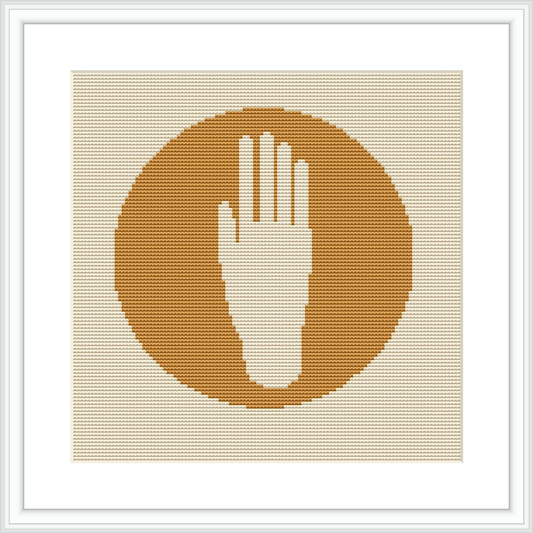 The image depicts a framed cross stitch pattern with a central hand silhouette in a neutral shade against a solid yellow circular background. The frame is white, complementing the simplicity of the design.