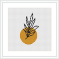 The image depicts a cross-stitch pattern featuring a stylized plant with long narrow leaves protruding from a round mustard yellow vase. The design is presented on a square grid, surrounded by a white border within a black frame.